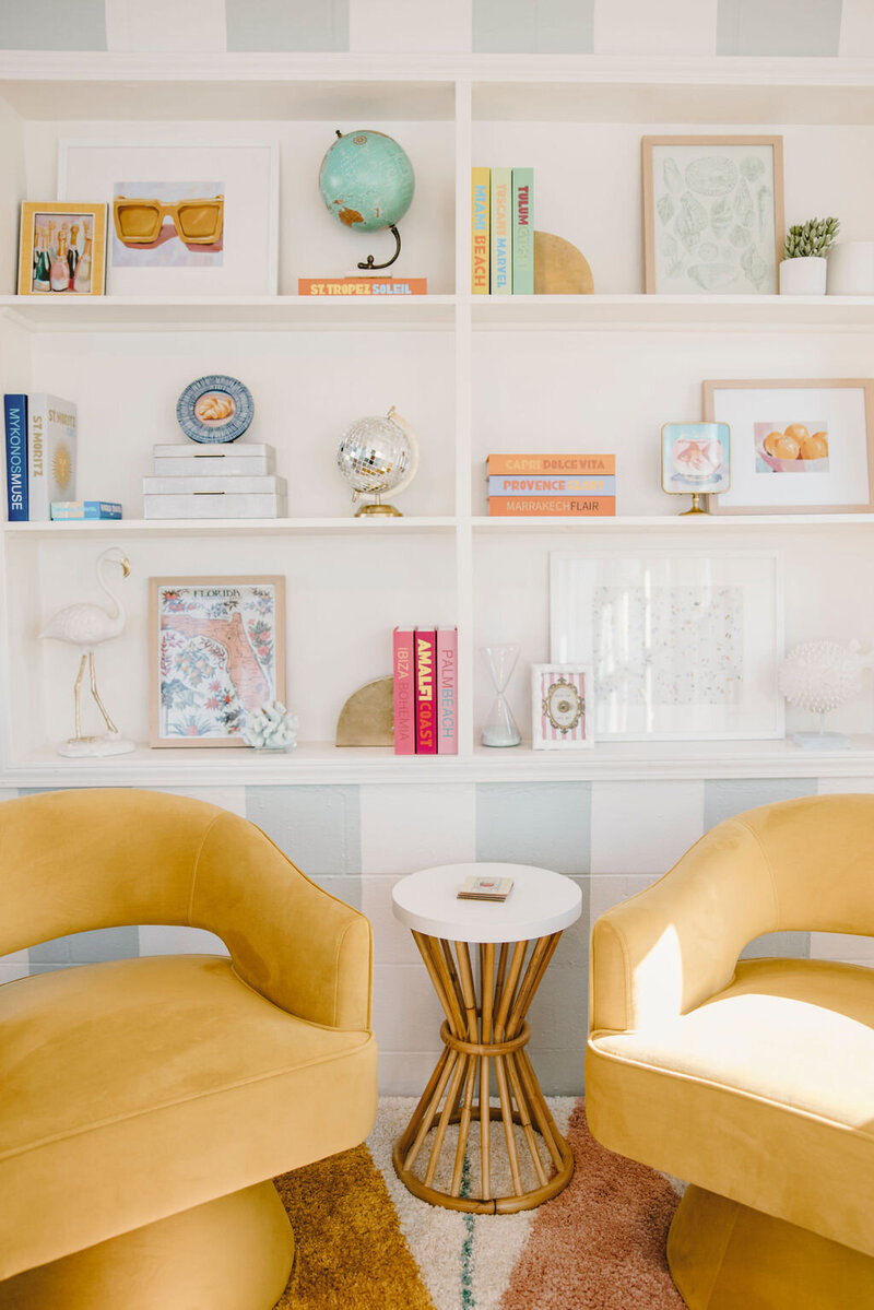 built-in bookshelf, yellow arm chairs, bamboo table