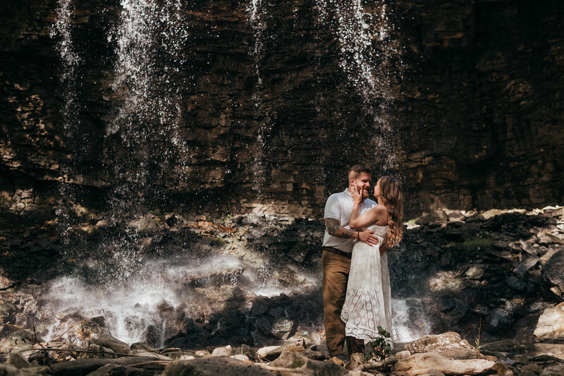 bride and groom hugging while holding bouquet