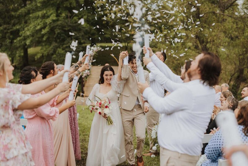 Confetti cannons pop for bride and groom's recessional
