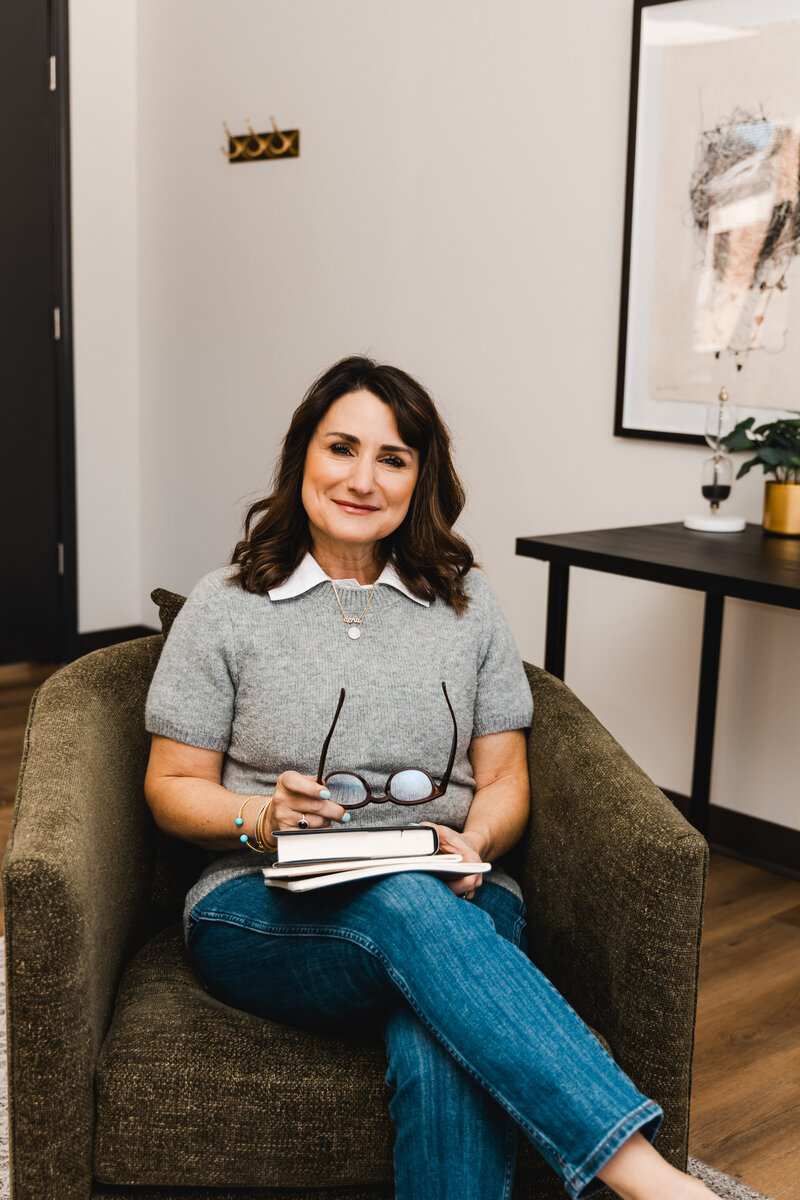 Dena smiling while sitting in her office