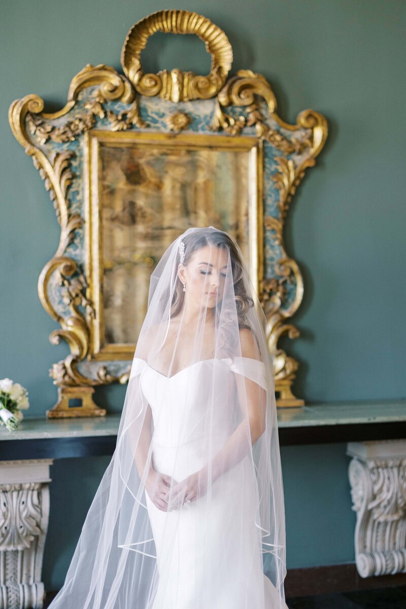 bride  looking down covered by her veil