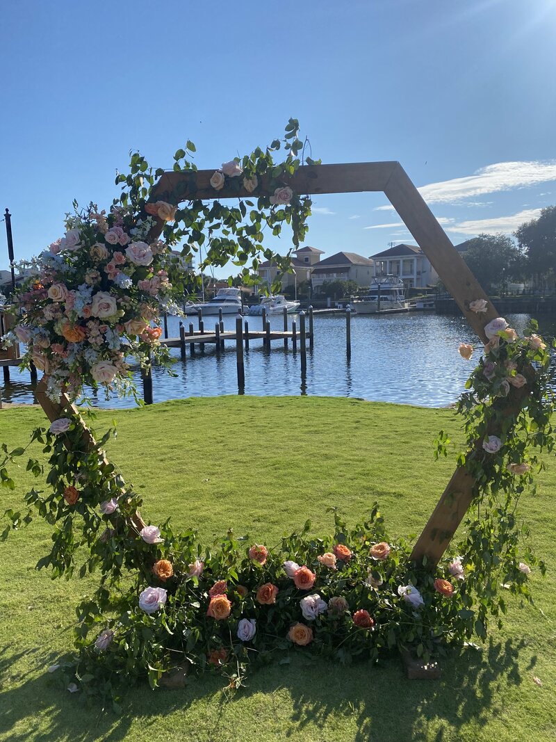 Venue Waterfront Green with Octagon Arbor with Florals at Palafox Wharf Waterfront Venue