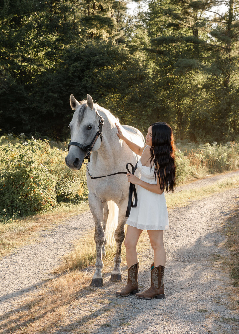 Equine lifestyle photography: girl and horse on a Vermont dirt path - a timeless connection 