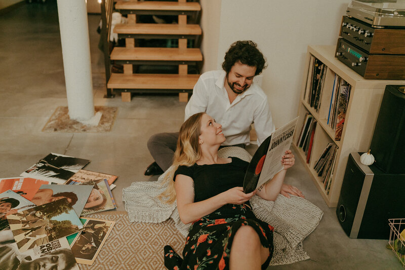 An engaged couple taking engagement photos in their apartment in downtown Minneapolis