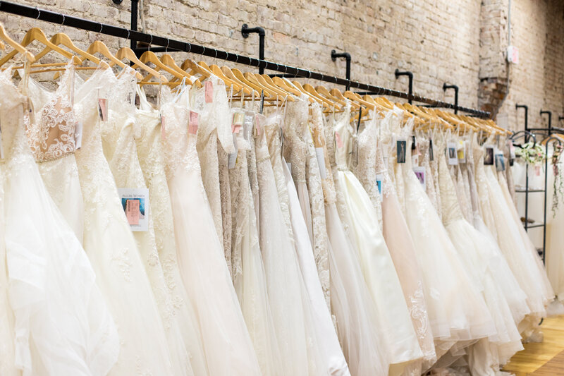 wedding gowns hanging on a rack at a bridal salon in Clarksville, TN