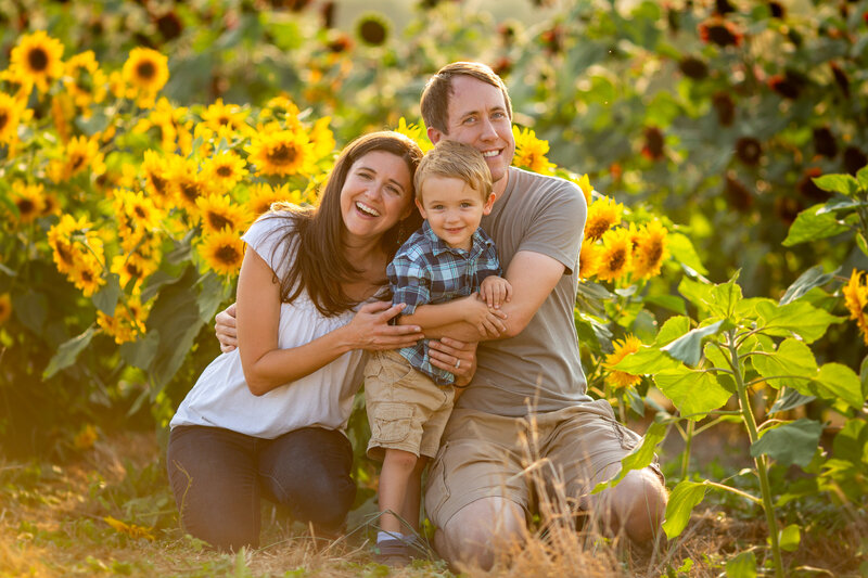 Family in a sunflower field by Be Thou My Vision Photography