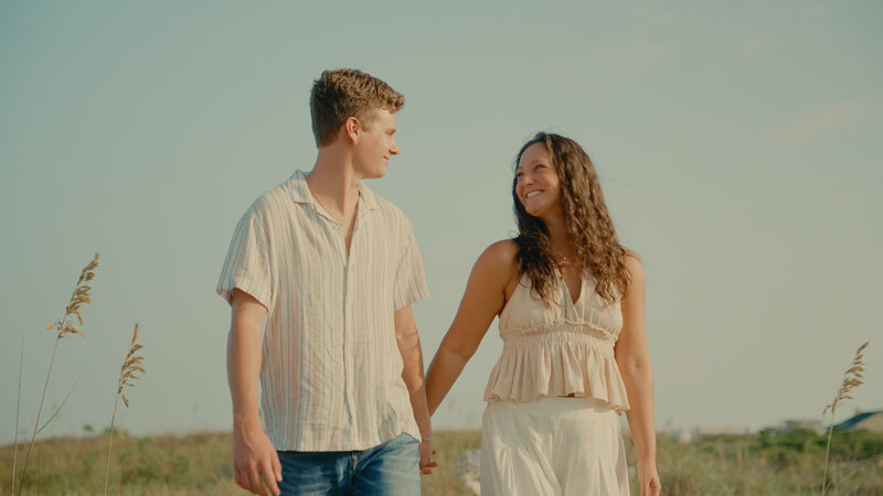 Couple embraces on a cliff.