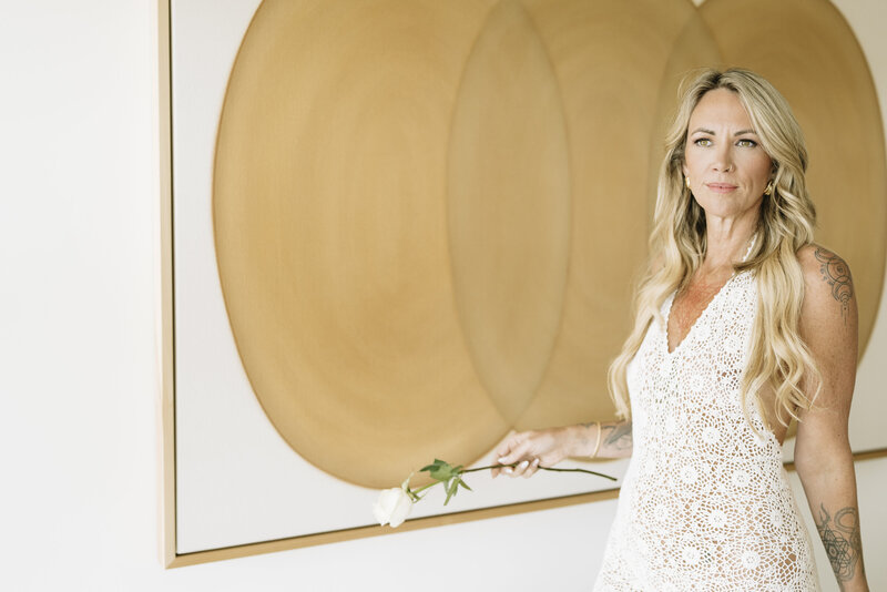 Aine Rock in a white lace dress