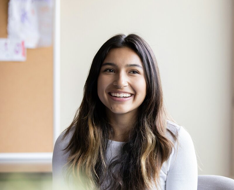 young woman smiling sitting in an office