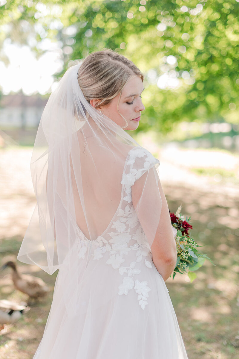 a bride posing in her wedding dress and veil