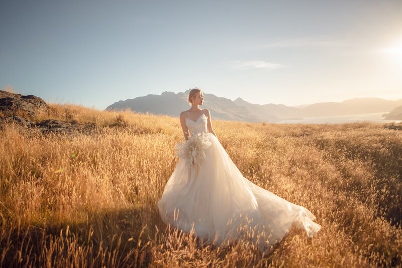 A golden light outdoor photoshoot of a woman wearing a couture dress.