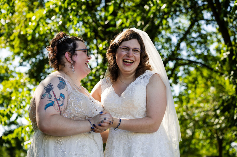 Brides laughing together on their Michigan wedding day