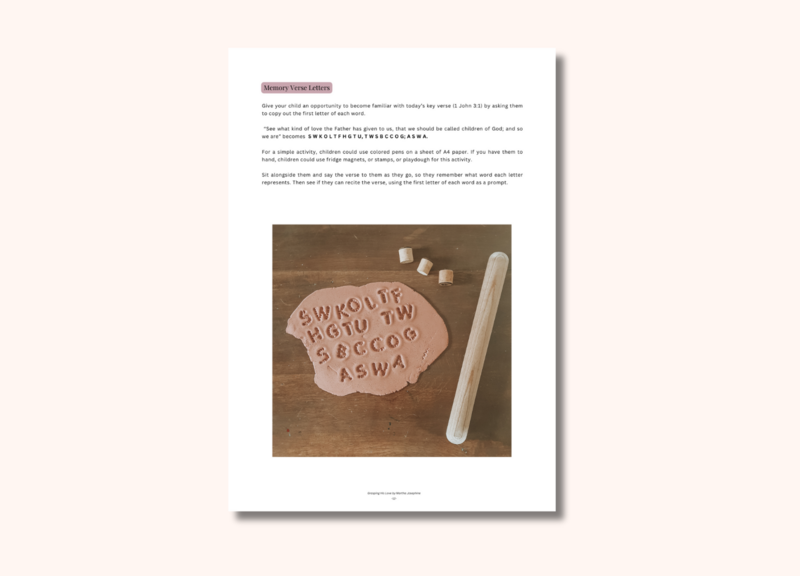 An image of a piece of pink playdough and a rolling pin. Letters have been stamped into the playdough.