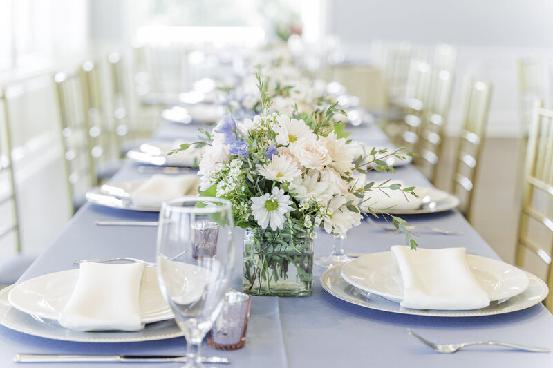 Brick Landing-a long wedding table scape with blush, white, blue centerpieces and flowers
