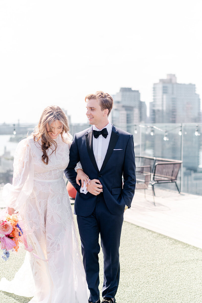 bride and groom walking arm in arm