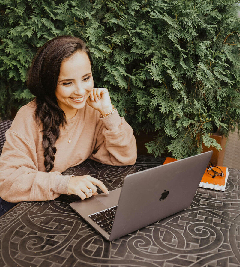 Girl Smiling at Macbook
