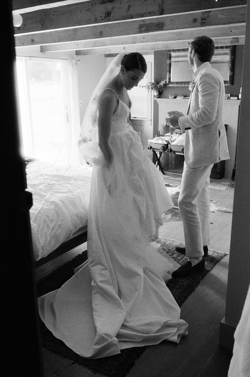 Bride gazes at the groom during dinner at their wedding reception