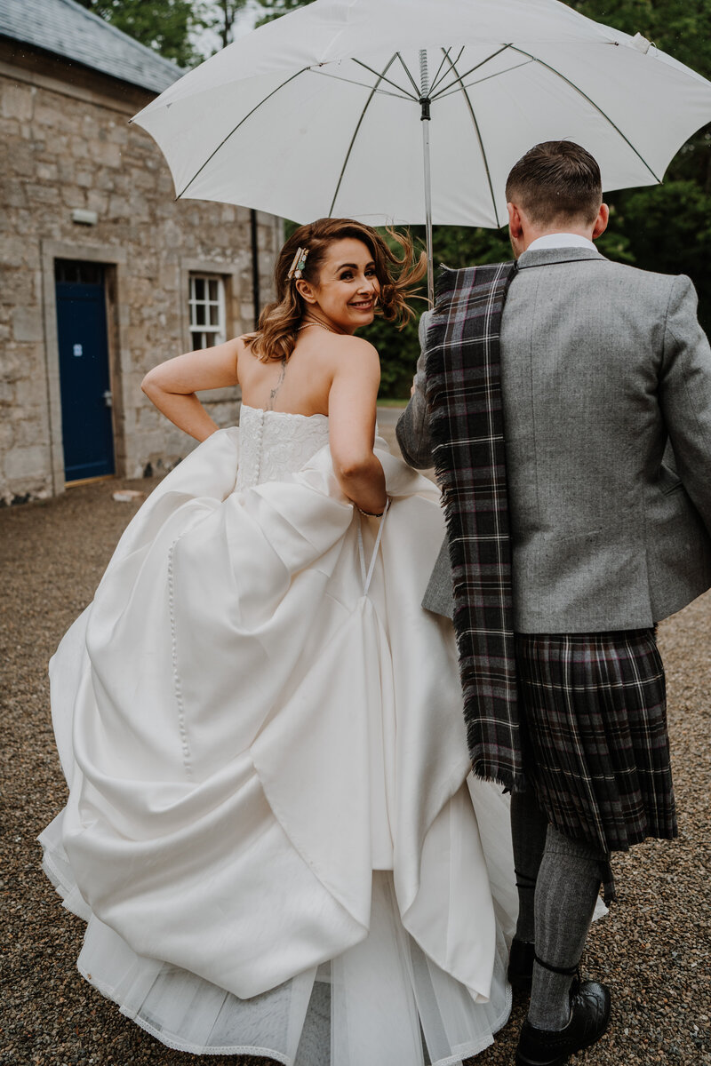 newly weds embrace in the gardens of Dunglass Estate