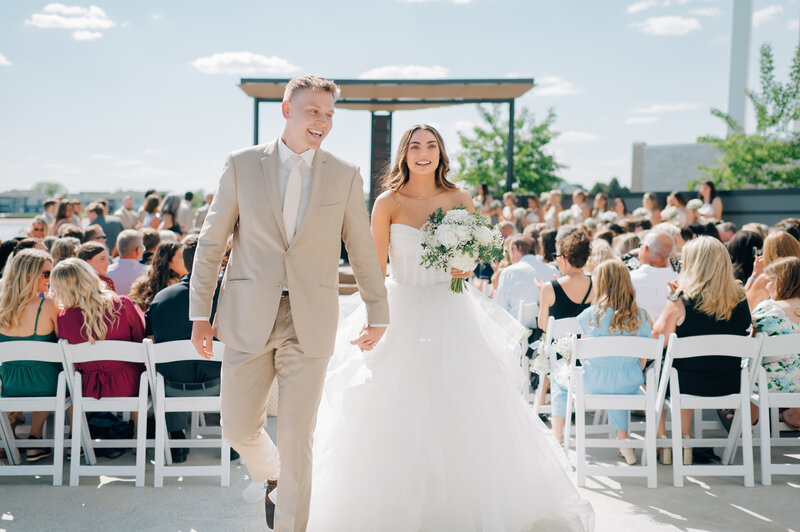 Drone photo from above of a bride walking down the aisle. Planned by Omaha wedding planner, Lovestruck Events. Photo by Anna Brace, a wedding photographer in Omaha NE.