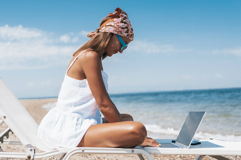 woman typing on laptop outside
