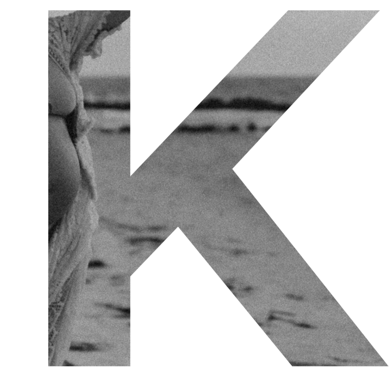 Large letter K overlayed with background image for parallax effect.