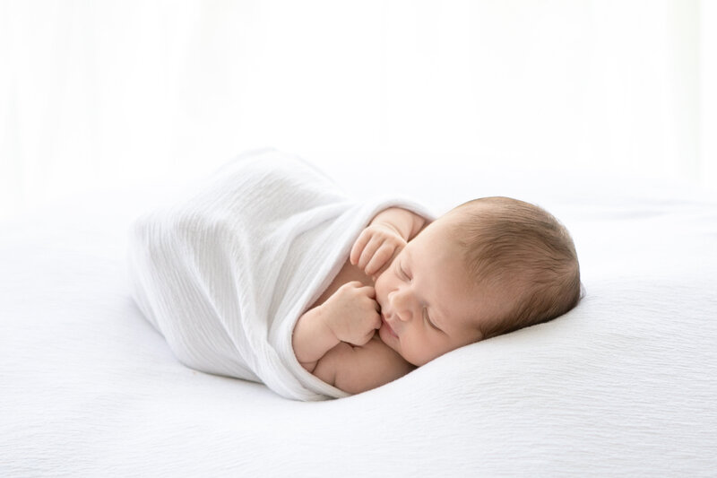 Newborn baby wrapped in white blanket - newborn photographer marlow buckinghamshire