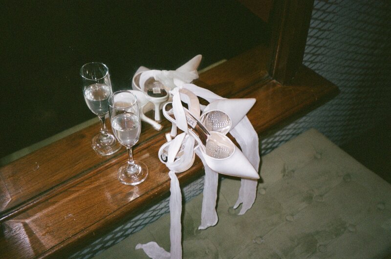 Film photos getting ready bridal suite, shoes and champagne