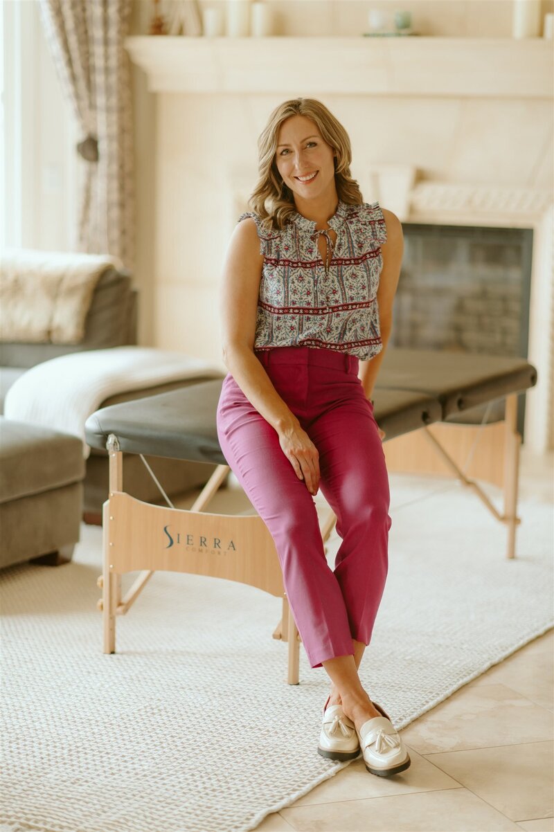 Physical therapist Gwen sits on a couch representing her in home concierge physical therapy services in the Portland area. 