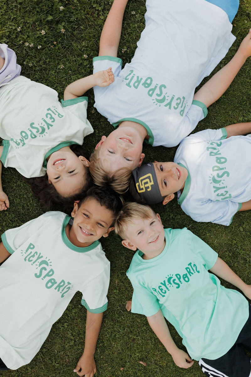 kids sitting in a circle laying on ground