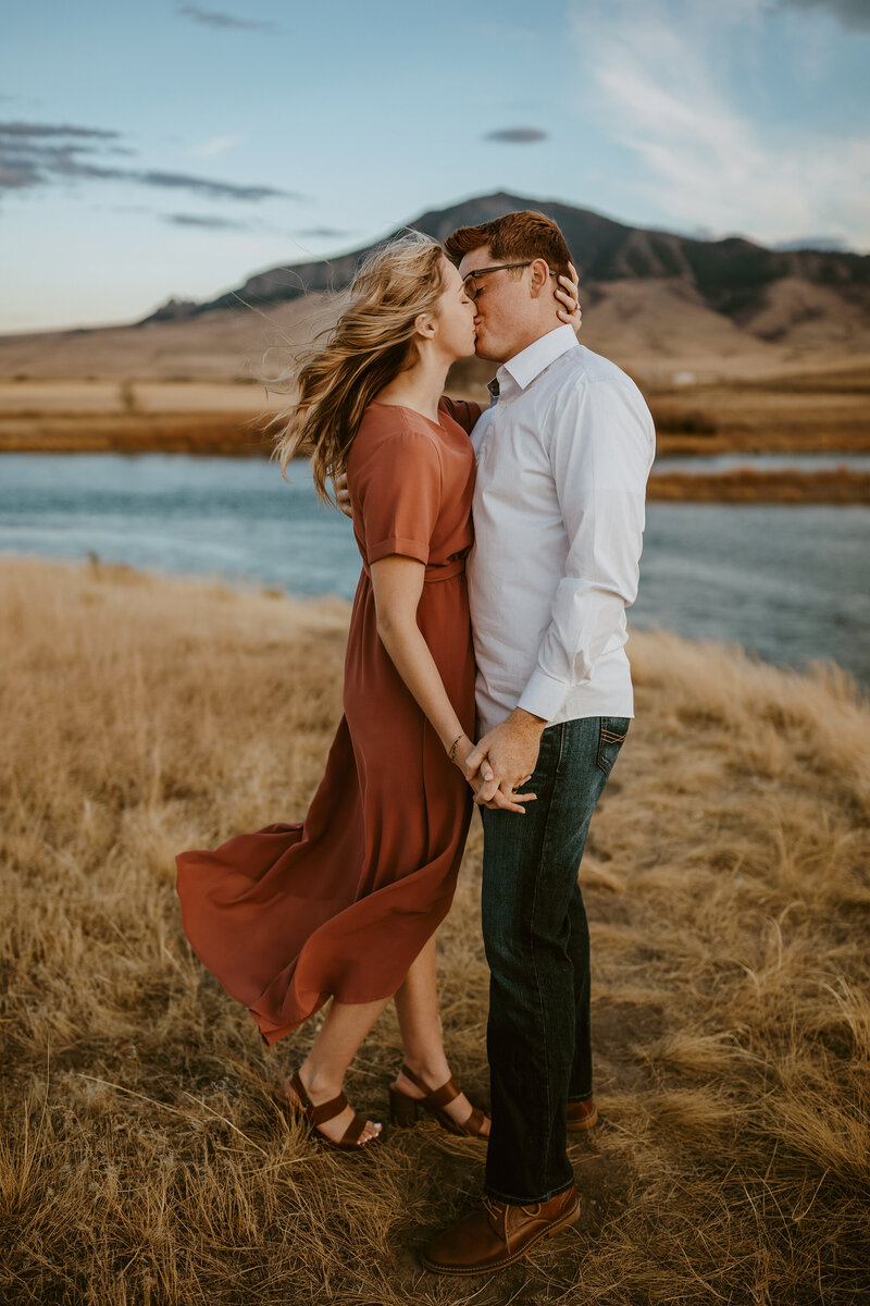 a couple kissing in the windy mountain landscape