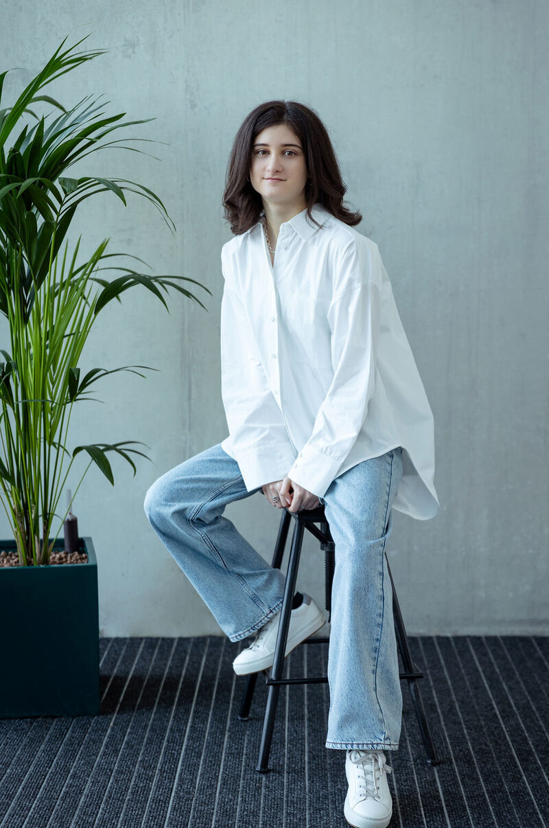 Portrait of a person sitting on a stool