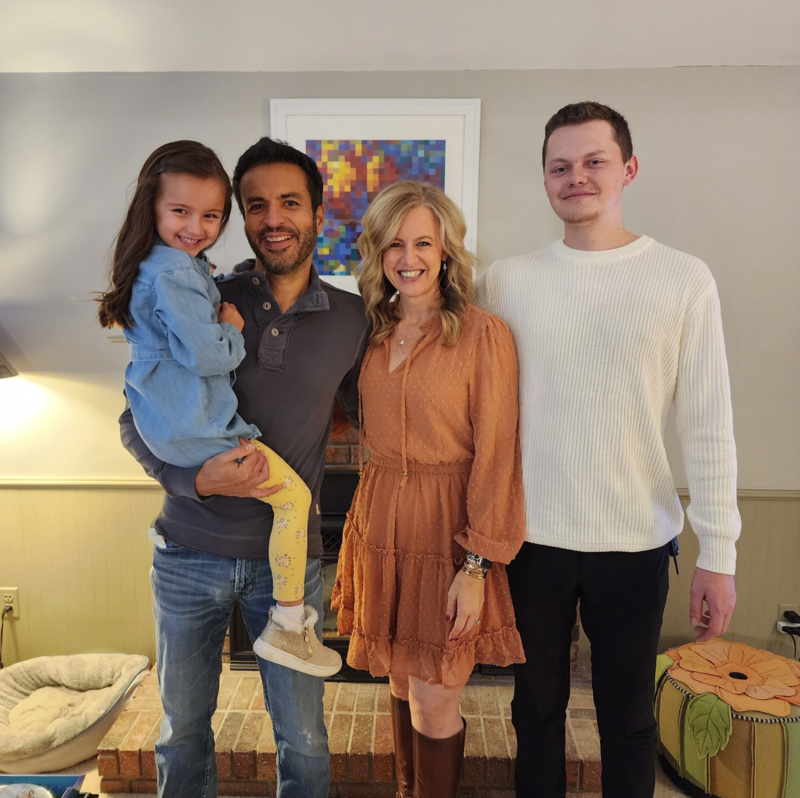 Ashley Malik online health and nutrition coach standing with family