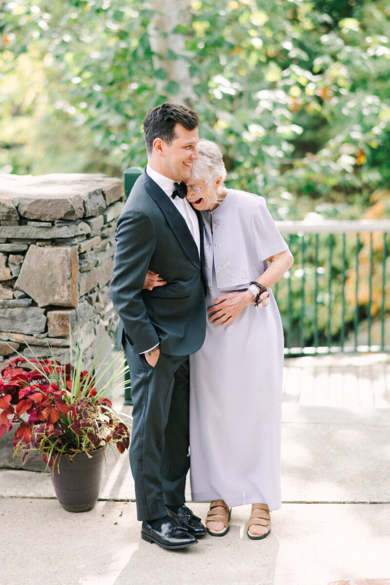groom hugs grandmother during an emotional moment