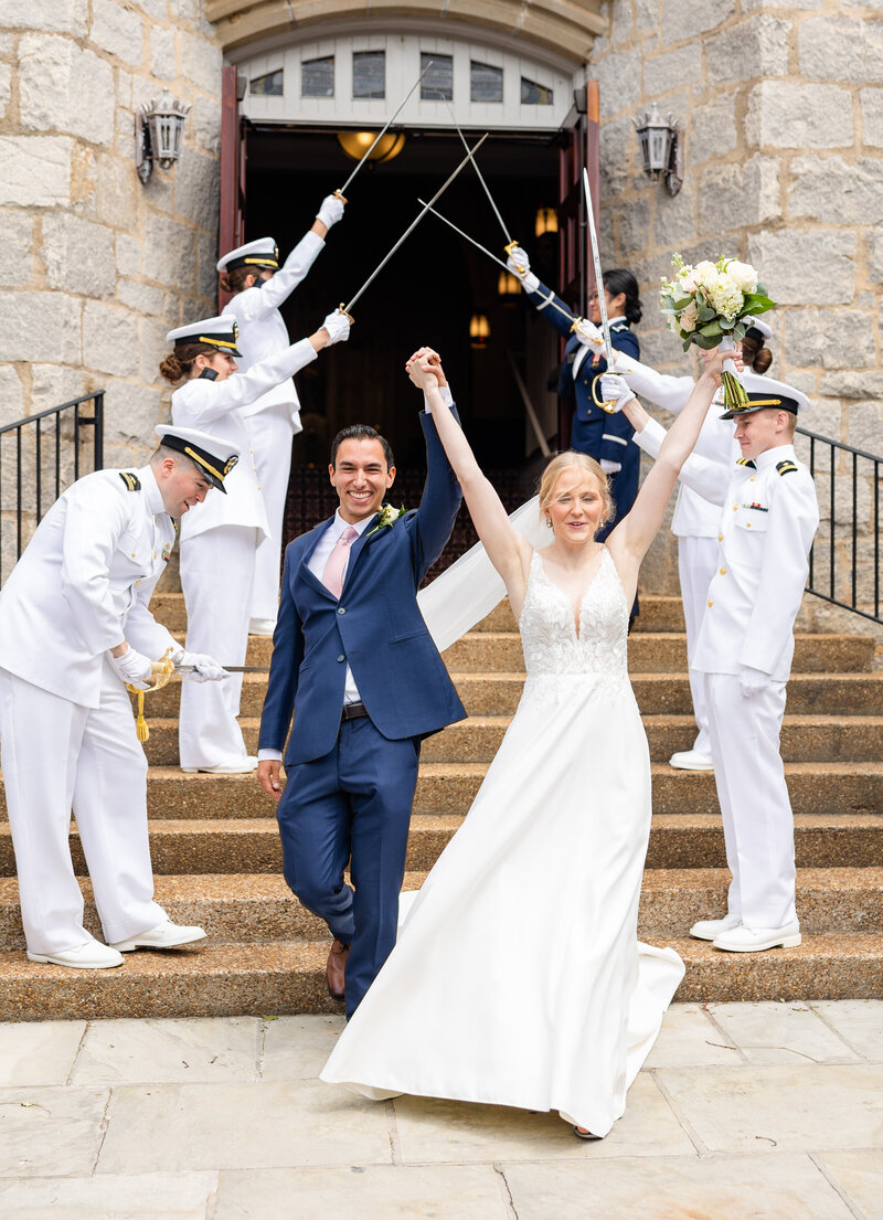 bride and groom celebrating while surrounded by military members