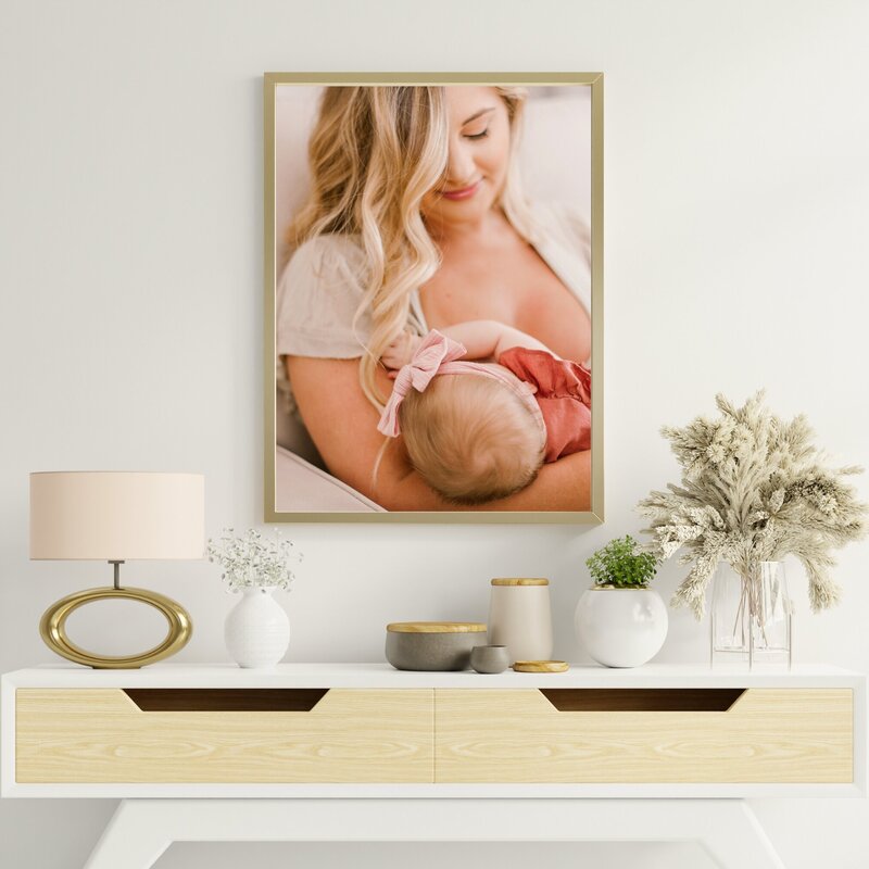 Modern wall mockup of a newborn baby breastfeeding with her mother during their Orlando newborn photography session