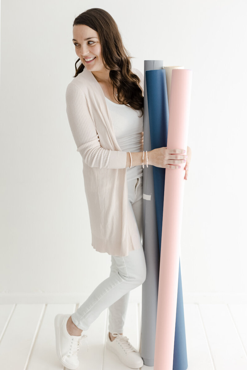 Nicole holding rolls of paper