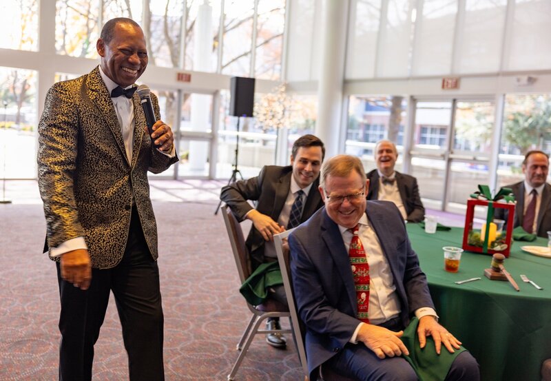 a speaker laughing with a guest at an event