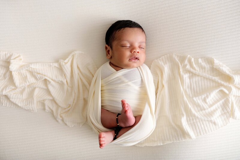 Wrapped newborn pose on beanbag