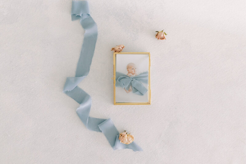 Artwork image of 4x6 prints of baby set on a blue hand painted canvas with pink flowers and blue ribbon