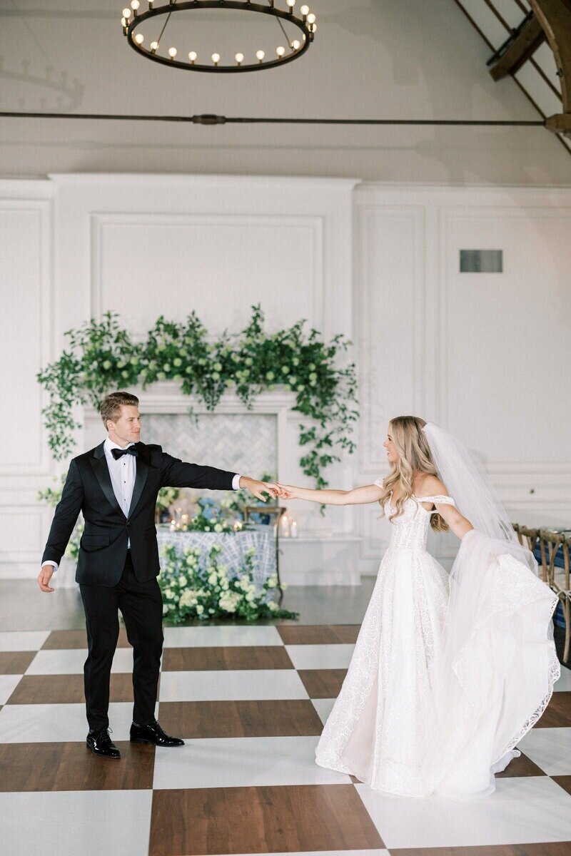 Bride and groom sharing a romantic first dance at their Milwaukee wedding reception, captured by a professional wedding photographer, Emily Barbara.