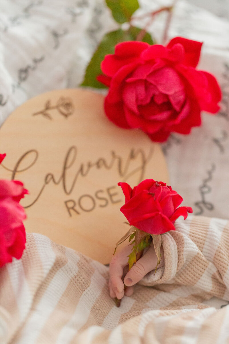a sign with Calvary's name on it surrounded by roses