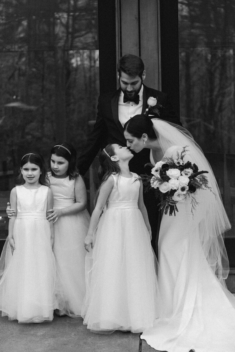 bride kisses flower girls