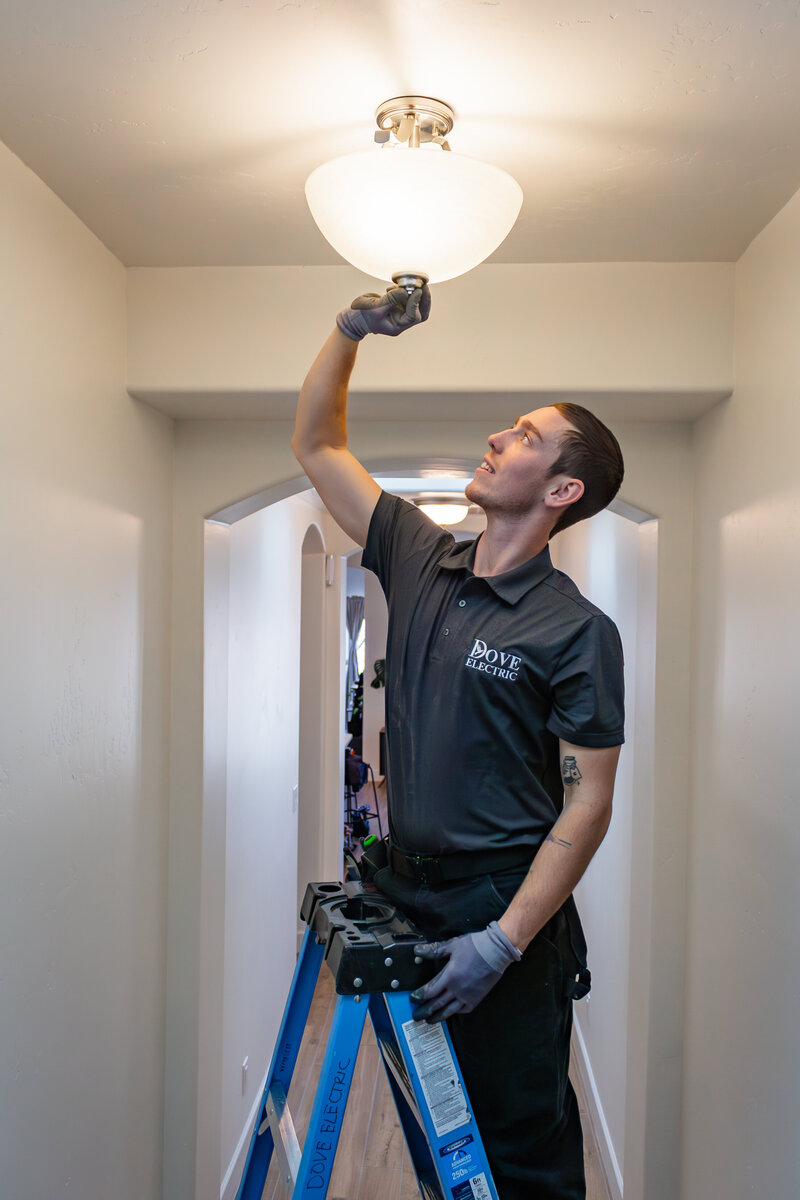 Dove Electric in Albuquerque working on hallway light in home