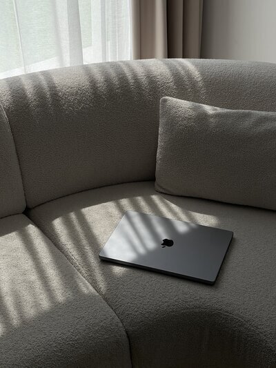 Laptop on couch to show Flourish Foundry Designs branding and website design​