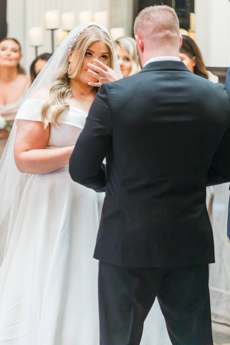 bride crying as groom says his vows