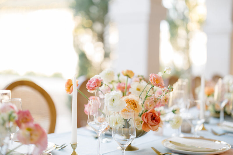 brightly lit table setting with florals