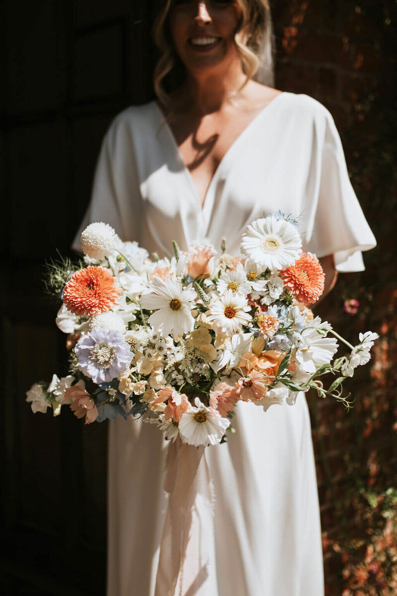 Bride holding a bouquet of flowers at Broadfield Court