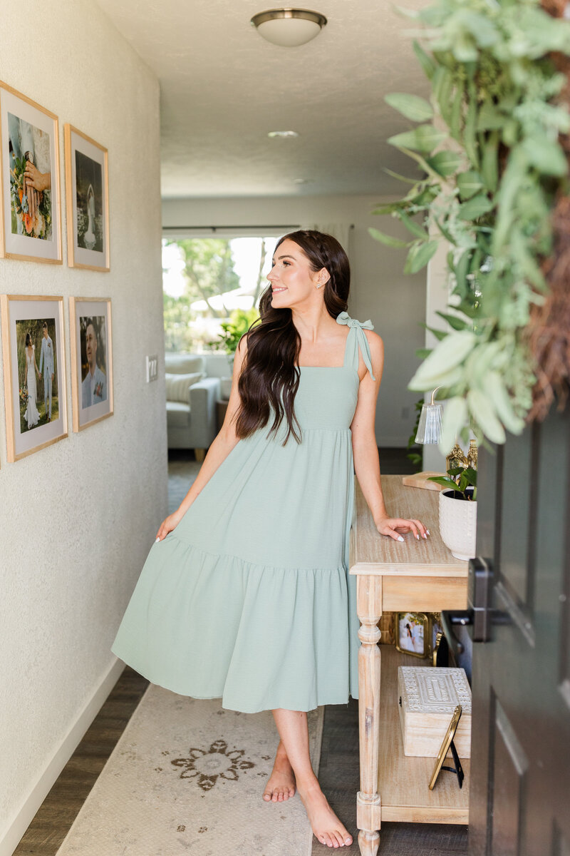 Kali, a wedding and senior photographer in Lewiston, Idaho, smiling in a sunlit outdoor setting.