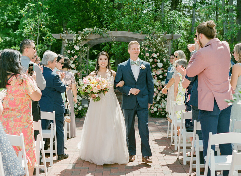 Bride and groom walking down the aisle after being announced husband and wife