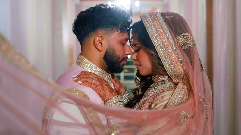 Urmi & Mashood gracefully hug each other as they close their eyes for their grand portrait at marriott westfields.